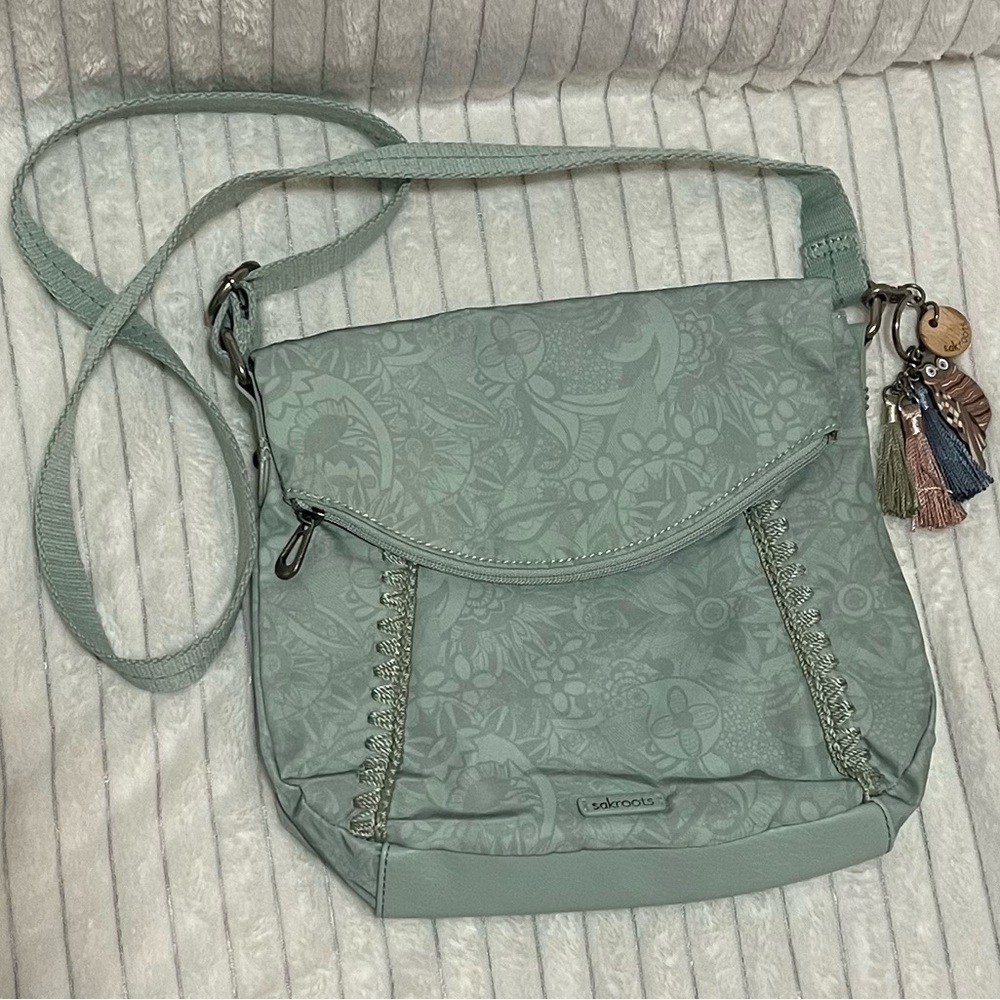 Sakroot Foldover Crossbody. Light Sage Green in color. Zipper foldover pocket.
